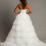 White wedding dress with a bushier top and a bushier puffy layered skirt