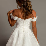 Off the shoulder lace all over ballgown wedding dress with a corset back