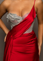 Red satin column shaped dress with one shoulder strap and high slit for hire