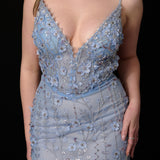 Ethereal blue elegance with floral embellishments and a dramatic thigh-high slit.