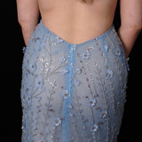 Ethereal blue elegance with floral embellishments and a dramatic thigh-high slit.
