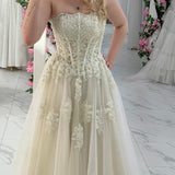 romantic white and cream A-line wedding dress with elegant floral pearl detailing