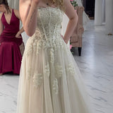romantic white and cream A-line wedding dress with elegant floral pearl detailing