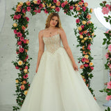 white wedding ballgown featuring a straight neckline, delicate beaded straps, sheer sparkling bodice, basque waistline, and corset back.