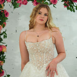 Light champagne wedding ballgown featuring a straight neckline, delicate beaded straps, sheer sparkling bodice, basque waistline, and corset back for hire