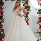 Light champagne wedding ballgown featuring a straight neckline, delicate beaded straps, sheer sparkling bodice, basque waistline, and corset back for hire