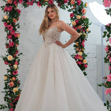 Light champagne wedding ballgown featuring a straight neckline, delicate beaded straps, sheer sparkling bodice, basque waistline, and corset back for hire