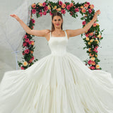 white wedding ballgown with straight neckline, basque waist, corset back, and layered skirt for hire