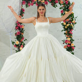 white wedding ballgown with straight neckline, basque waist, corset back, and layered skirt.