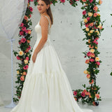 white wedding ballgown with straight neckline, basque waist, corset back, and layered skirt for hire