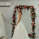 white wedding ballgown with straight neckline, basque waist, corset back, and layered skirt.