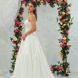 white wedding ballgown with straight neckline, basque waist, corset back, and layered skirt for hire