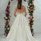 white wedding ballgown with straight neckline, basque waist, corset back, and layered skirt for hire