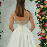 white wedding ballgown with straight neckline, basque waist, corset back, and layered skirt for hire