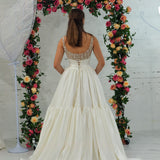 white wedding ballgown with straight neckline, basque waist, corset back, and layered skirt for hire