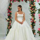 white wedding ballgown with straight neckline, basque waist, corset back, and layered skirt for hire
