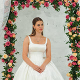 white wedding ballgown with straight neckline, basque waist, corset back, and layered skirt for hire