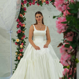 white wedding ballgown with straight neckline, basque waist, corset back, and layered skirt for hire