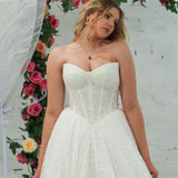 white lace ballgown featuring a strapless sweetheart neckline, basque waistline, corset back, and voluminous crinoline skirt