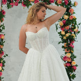 white lace ballgown featuring a strapless sweetheart neckline, basque waistline, corset back, and voluminous crinoline skirt