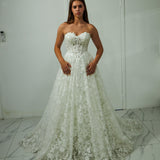 A-line gown with corseted structure and floral sparkle.