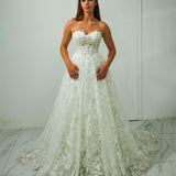 A-line gown with corseted structure and floral sparkle.