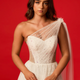 One-shoulder corset gown with tulle drape.