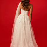 One-shoulder corset gown with tulle drape.