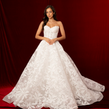 Lace print dress with a structured corset back and a long ball gown style flowing skirt for hire