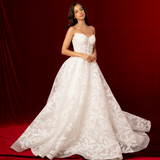 Lace print dress with a structured corset back and a long ball gown style flowing skirt for hire