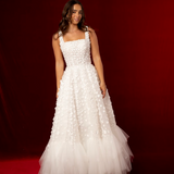 Romantic A-line gown with 3D florals, glittered mesh, and soft tulle layers.