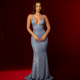 blue sequined mermaid gown featuring a plunging V neckline and criss-crossed corset back.