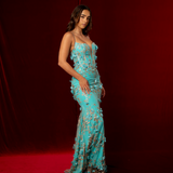 turquoise mermaid gown with plunging V neckline, exposed corset boning, and gold glitter floral appliqué.