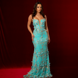 turquoise mermaid gown with plunging V neckline, exposed corset boning, and gold glitter floral appliqué.