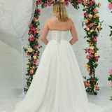 white lace ballgown featuring a strapless sweetheart neckline, basque waistline, corset back, and voluminous crinoline skirt