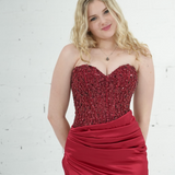Dazzling red mermaid gown featuring a beaded corset bodice, thigh-high slit, and elegant train.
