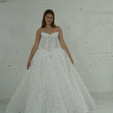 lace ballgown wedding dress featuring dramatic hips, corsetry, and timeless royal elegance