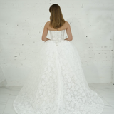 lace ballgown wedding dress featuring dramatic hips, corsetry, and timeless royal elegance