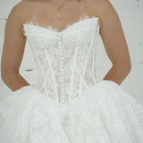 lace ballgown wedding dress featuring dramatic hips, corsetry, and timeless royal elegance