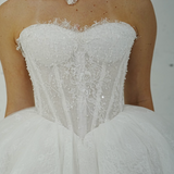ballgown wedding dress featuring sparkling lace, dramatic hips, and an elegant neck cuff for hire