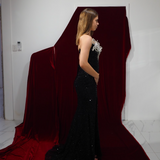 A glamorous black sequined mermaid gown with striking silver 3D couture embellishments.