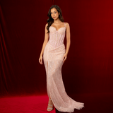 A baby pink mermaid formal gown with sweetheart neckline, exposed corset boning, beaded mesh, and elegant slit.