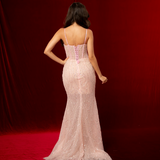 A baby pink mermaid formal gown with sweetheart neckline, exposed corset boning, beaded mesh, and elegant slit.