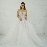 dazzling ballgown wedding dress featuring a crystal-encrusted bodice, glowing skirt, and regal elegance.