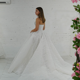 dazzling ballgown wedding dress featuring a crystal-encrusted bodice, glowing skirt, and regal elegance.