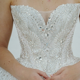 dazzling ballgown wedding dress featuring a crystal-encrusted bodice, glowing skirt, and regal elegance.