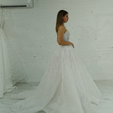 dazzling ballgown wedding dress featuring a crystal-encrusted bodice, glowing skirt, and regal elegance.