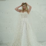 A-line wedding dress featuring 3D florals, sparkling lace, and a modern slit for hire