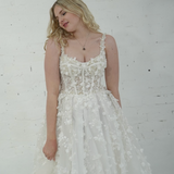 A-line wedding dress featuring 3D florals, sparkling lace, and a modern slit for hire