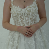 A-line wedding dress featuring 3D florals, sparkling lace, and a modern slit for hire